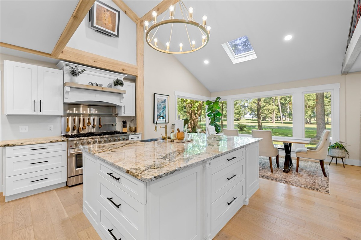 Gourmet kitchen with granite island and vaulted ceilings